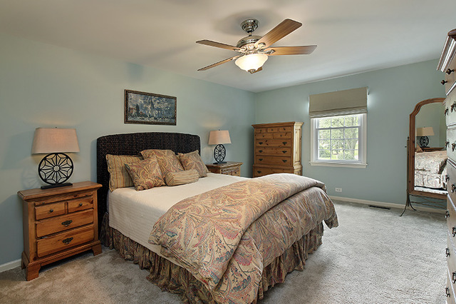2705 Cherry Lane Northbrook, IL 60062 - Photo 12 of 25 a bedroom with a bed a dresser and paintings on the wall