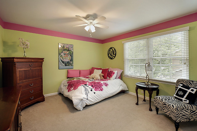 2705 Cherry Lane Northbrook, IL 60062 - Photo 15 of 25 a bedroom with a bed and a chandelier