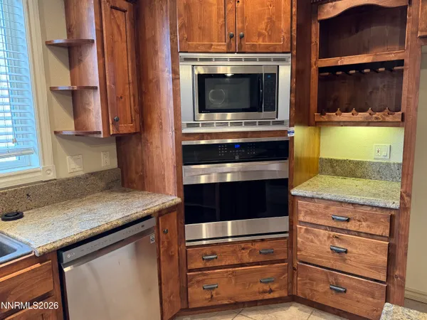 a kitchen with stainless steel appliances granite countertop a stove and a microwave