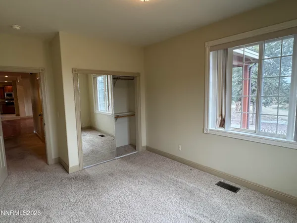 an empty room that has a large window