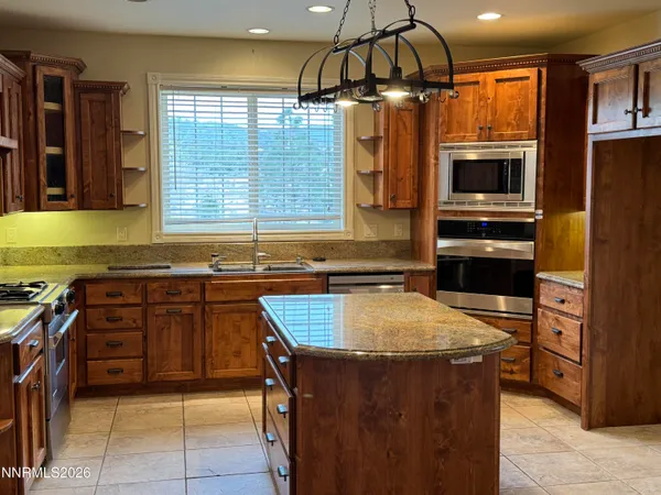 a kitchen with a stove a sink and a refrigerator