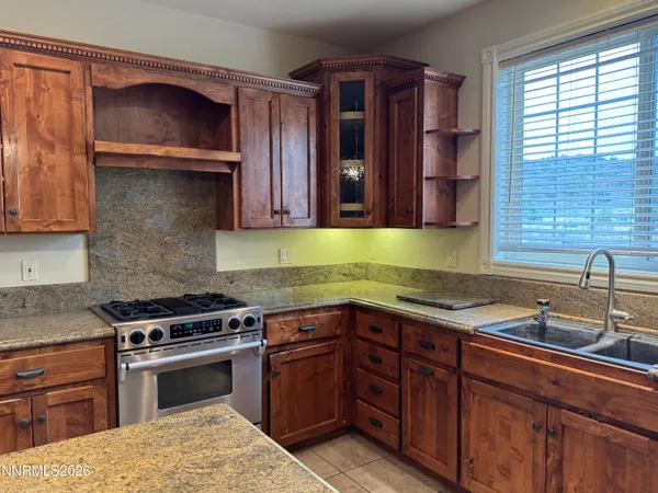 a kitchen with a sink stove and cabinets