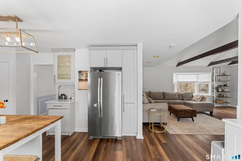 a kitchen with stainless steel appliances kitchen island granite countertop a refrigerator and a stove top oven