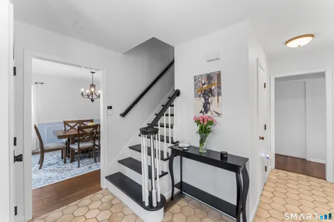 a view of entryway dining room and hall with wooden floor