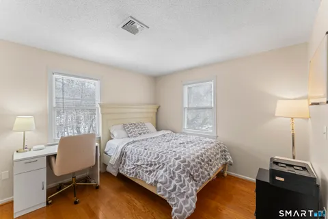 a bedroom with a bed and a lamp on table