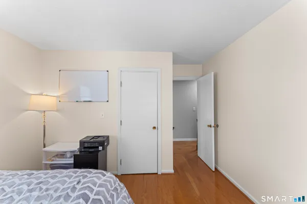 a bedroom with a bed and a lamp