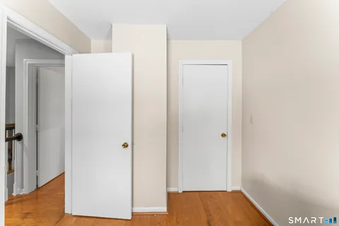 a bathroom with a granite countertop sink toilet and mirror