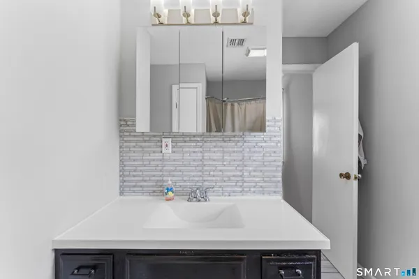 a bathroom with a sink and a mirror