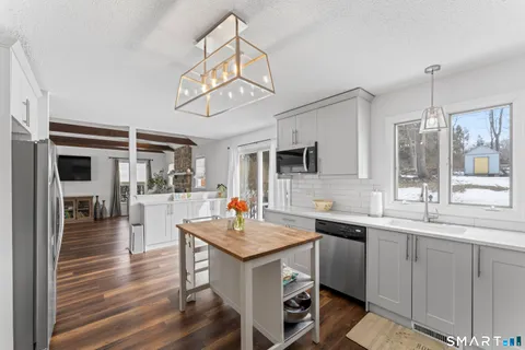 a kitchen with a sink cabinets and window