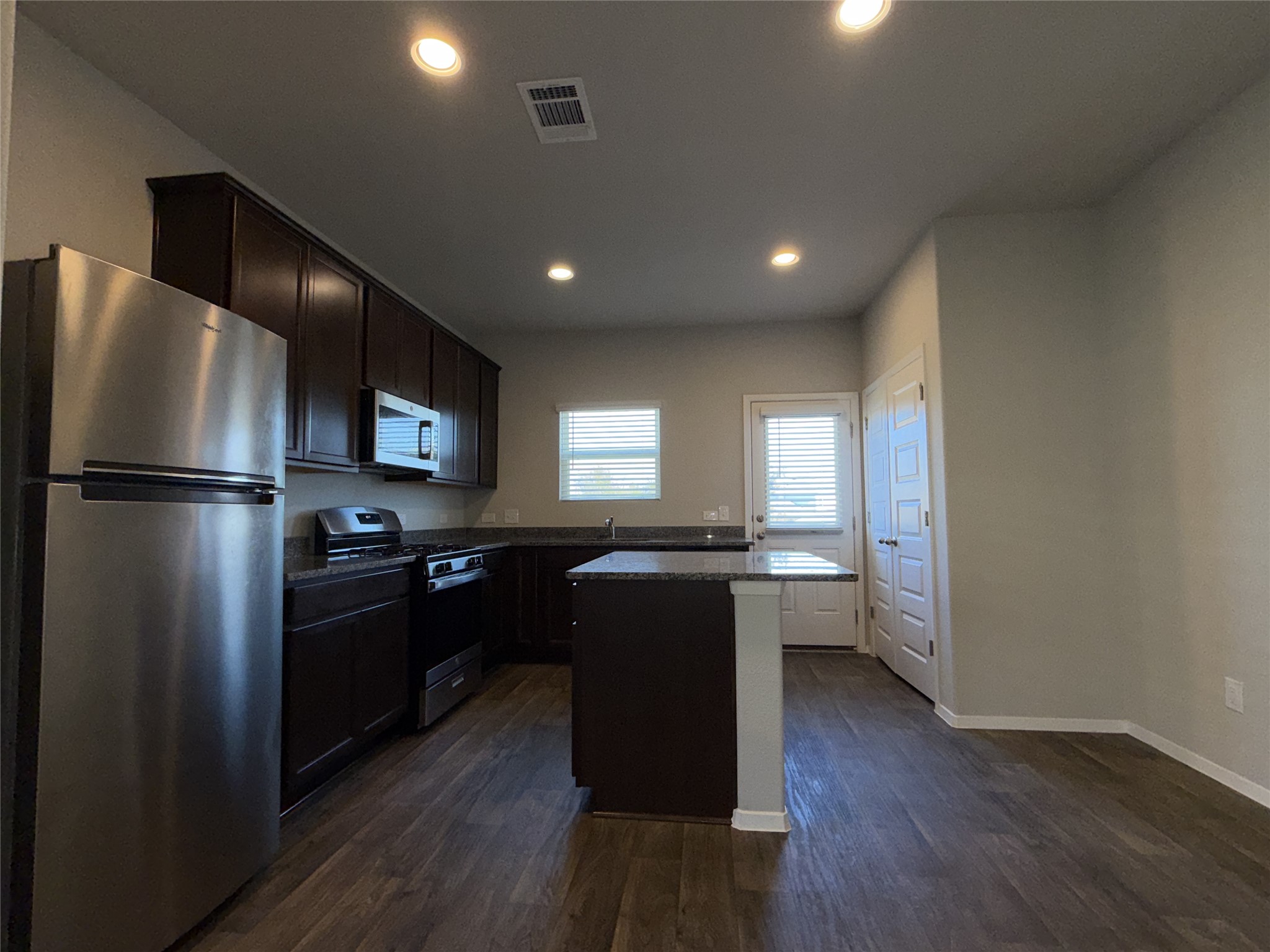 129 Tall Grass Drive Georgetown, TX 78628 - Photo 6 of 21 a kitchen with a refrigerator and a sink