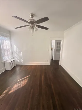 a view of a room with wooden floor and cabinet