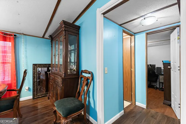 a view of a hallway with furniture and wooden floor