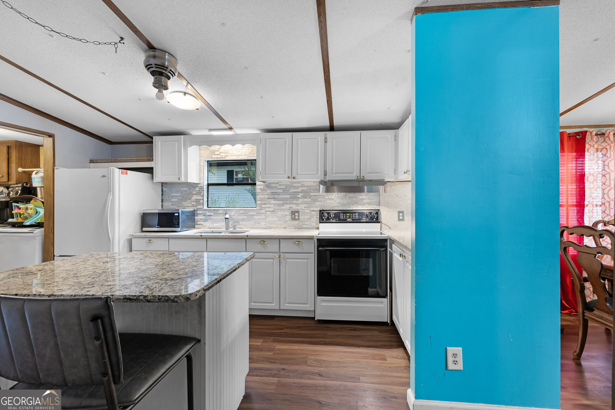 5758 Hickory Wood Lane, Unit 336 Buford, GA 30518 - Photo 15 of 28 a kitchen with stainless steel appliances granite countertop a stove refrigerator sink and microwave