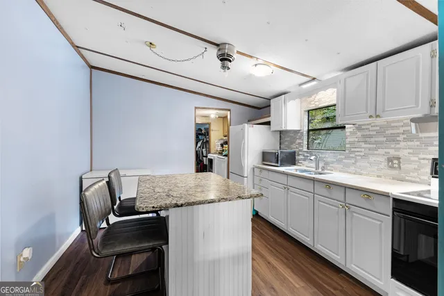a kitchen with a sink cabinets and window