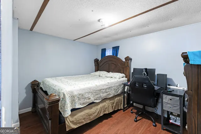 a bedroom with a bed and a desk