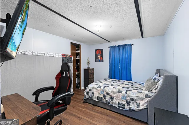 a bedroom with a bed next to a window