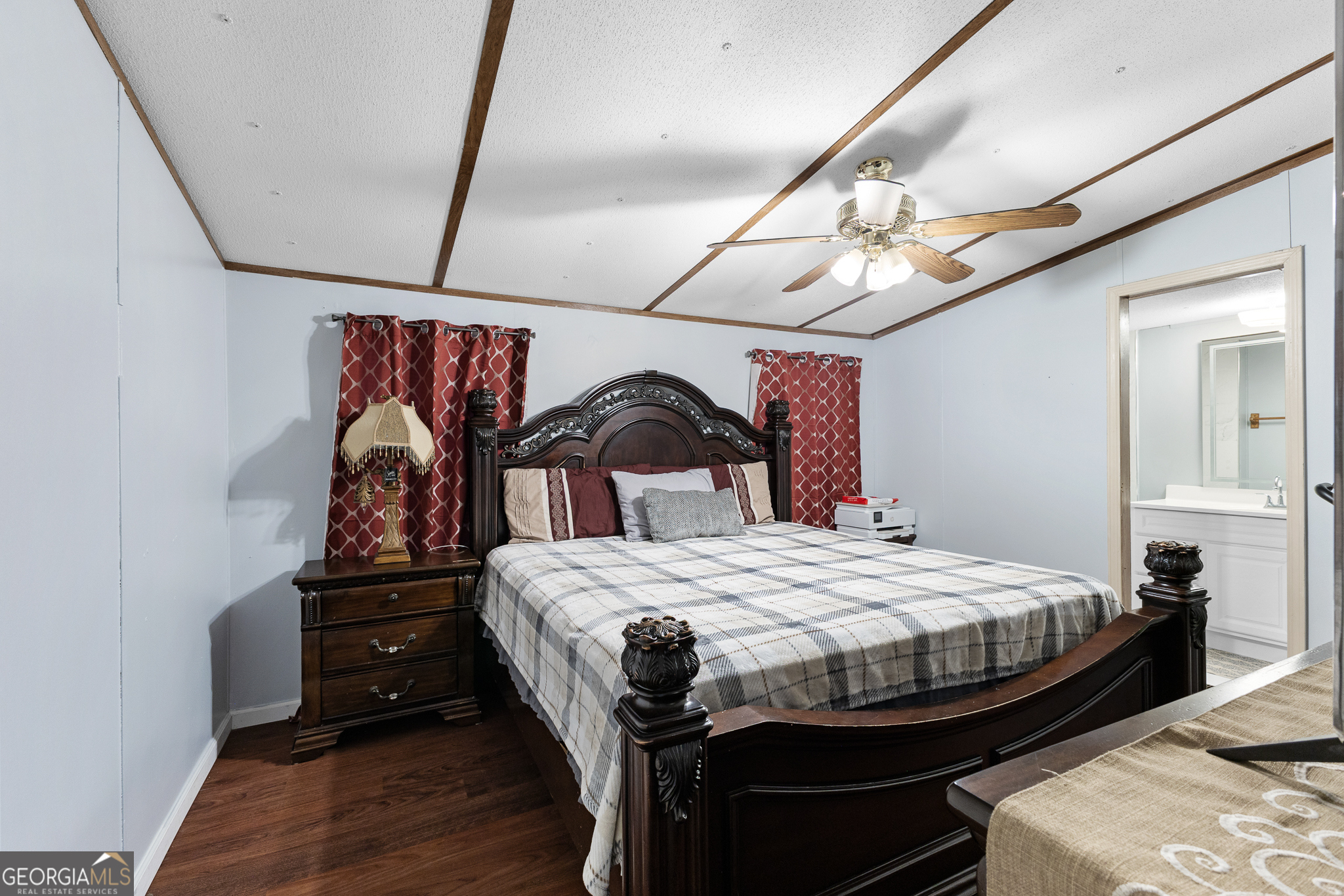 5758 Hickory Wood Lane, Unit 336 Buford, GA 30518 - Photo 19 of 28 a bedroom with a bed and a chandelier