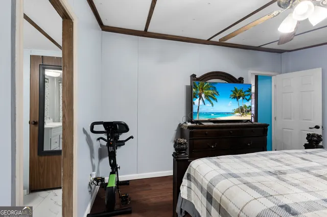 a bedroom with a bed and a black countertop white cabinet