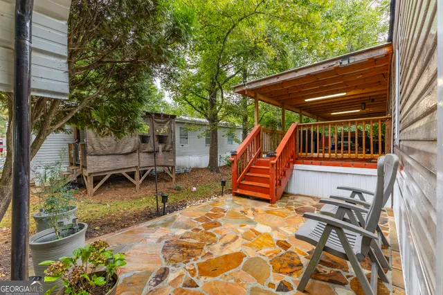 a backyard of a house with barbeque oven table and chairs