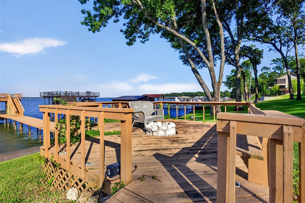 1113 Rim O The World Drive Tool, TX 75143 - Photo 29 of 40 Waterfront wood-plank deck featuring a built-in bench, wood railing, and a fire pit. Don't forget the S'mores fixings, kids and adults all love them.