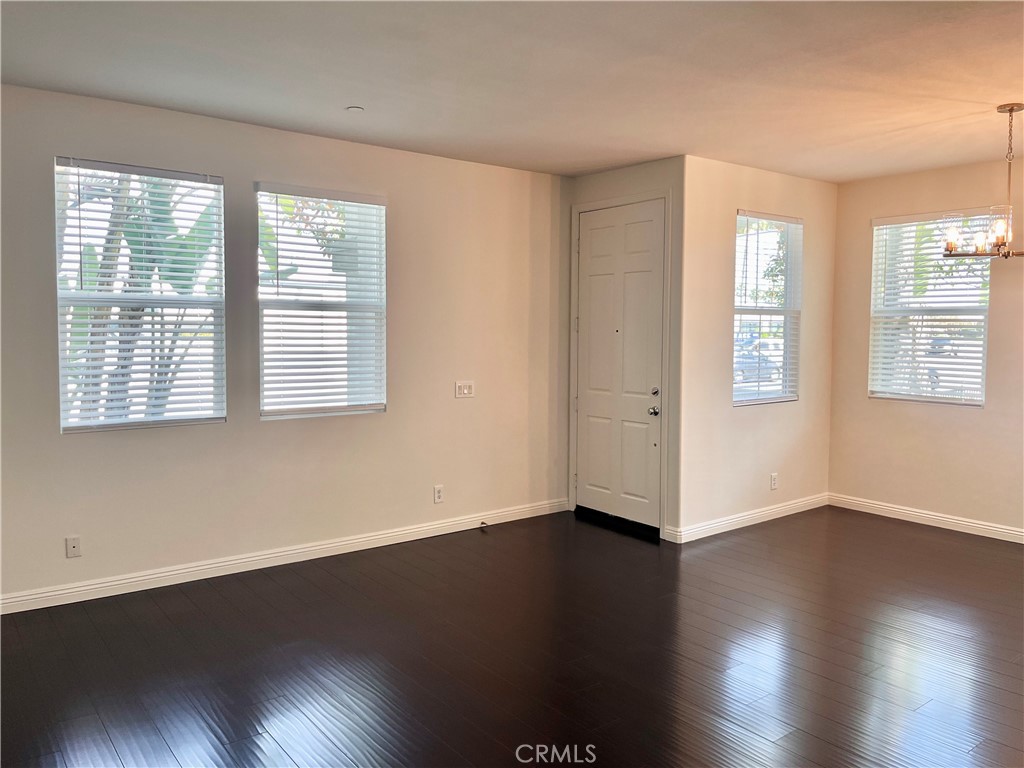 12 Jaynes Place Buena Park, CA 90621 - Photo 4 of 12 a view of an empty room with wooden floor and a window