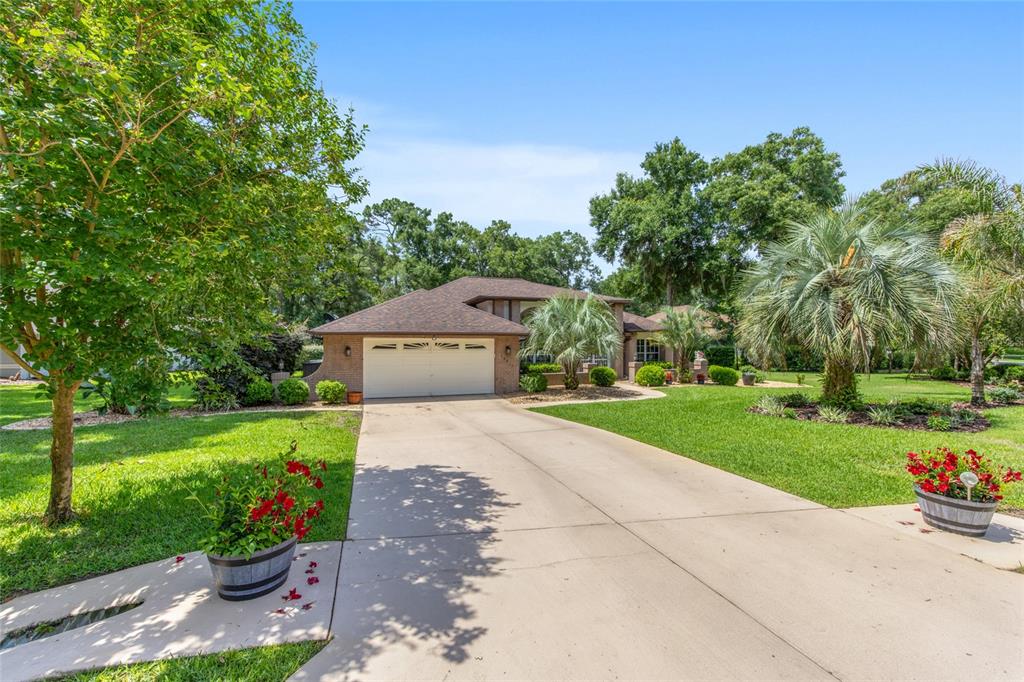 18825 Southwest 93rd Loop Dunnellon, FL 34432 - Photo 65 of 85 a front view of a house with a yard and garage