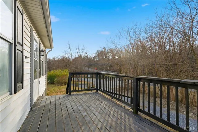 a view of a balcony with wooden floor and fence
