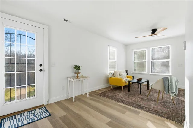 a spacious bedroom with a bed and wooden floor