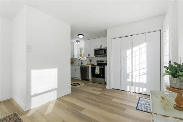 a kitchen with a refrigerator and windows