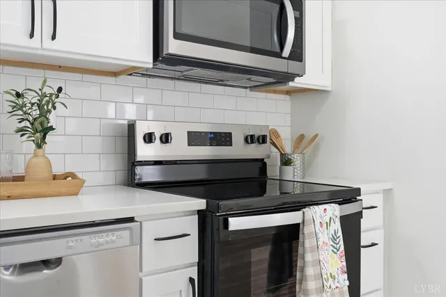 a kitchen with stainless steel appliances granite countertop a sink and cabinets