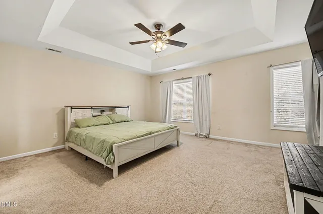 a living room with furniture a flat screen tv and a window