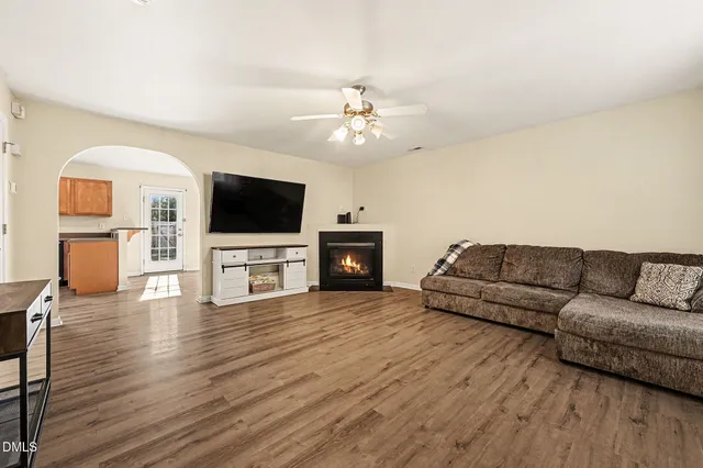 a dining room with wooden floor and a chandelier