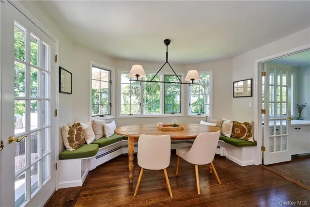 a view of a dining room with furniture window and wooden floor