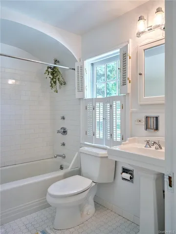 a bathroom with a sink a toilet and a bathtub