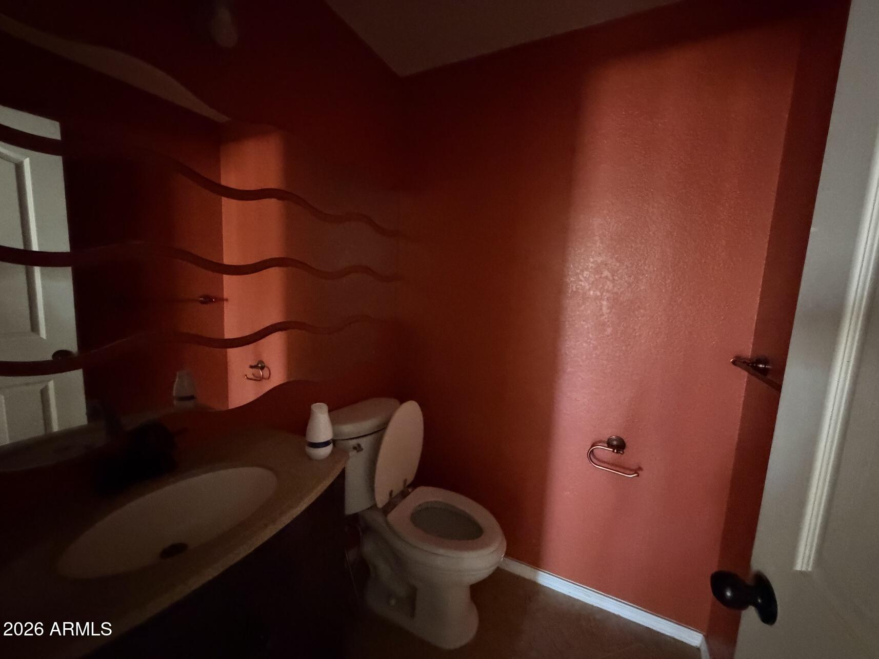 10807 West Monte Vista Road Avondale, AZ 85392 - Photo 17 of 33 a bathroom with a toilet and a sink