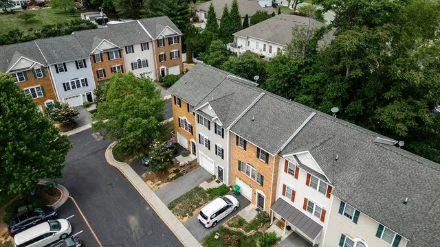 an aerial view of multiple houses with a yard