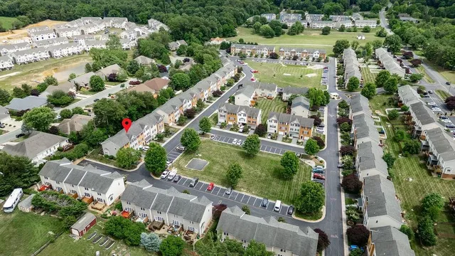 an aerial view of residential houses with outdoor space and street view