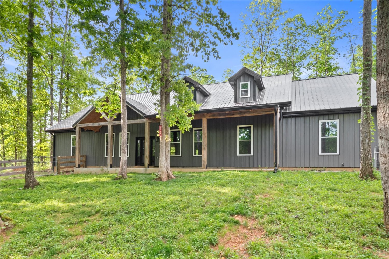 8360 Pinewood Road Lyles, TN 37098 - Photo 1 of 49 a front view of a house with garden