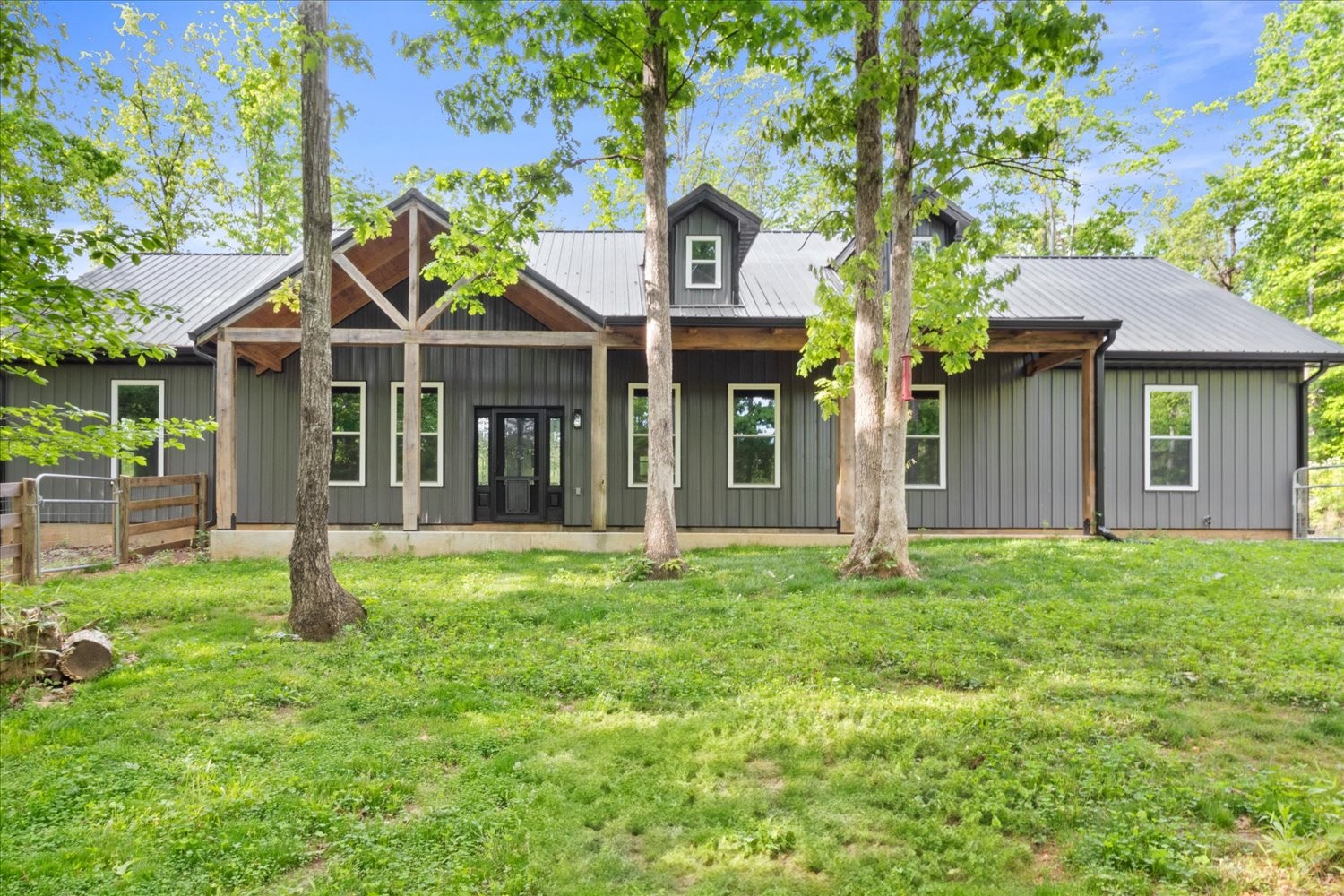 8360 Pinewood Road Lyles, TN 37098 - Photo 2 of 49 a house with green field in front of it