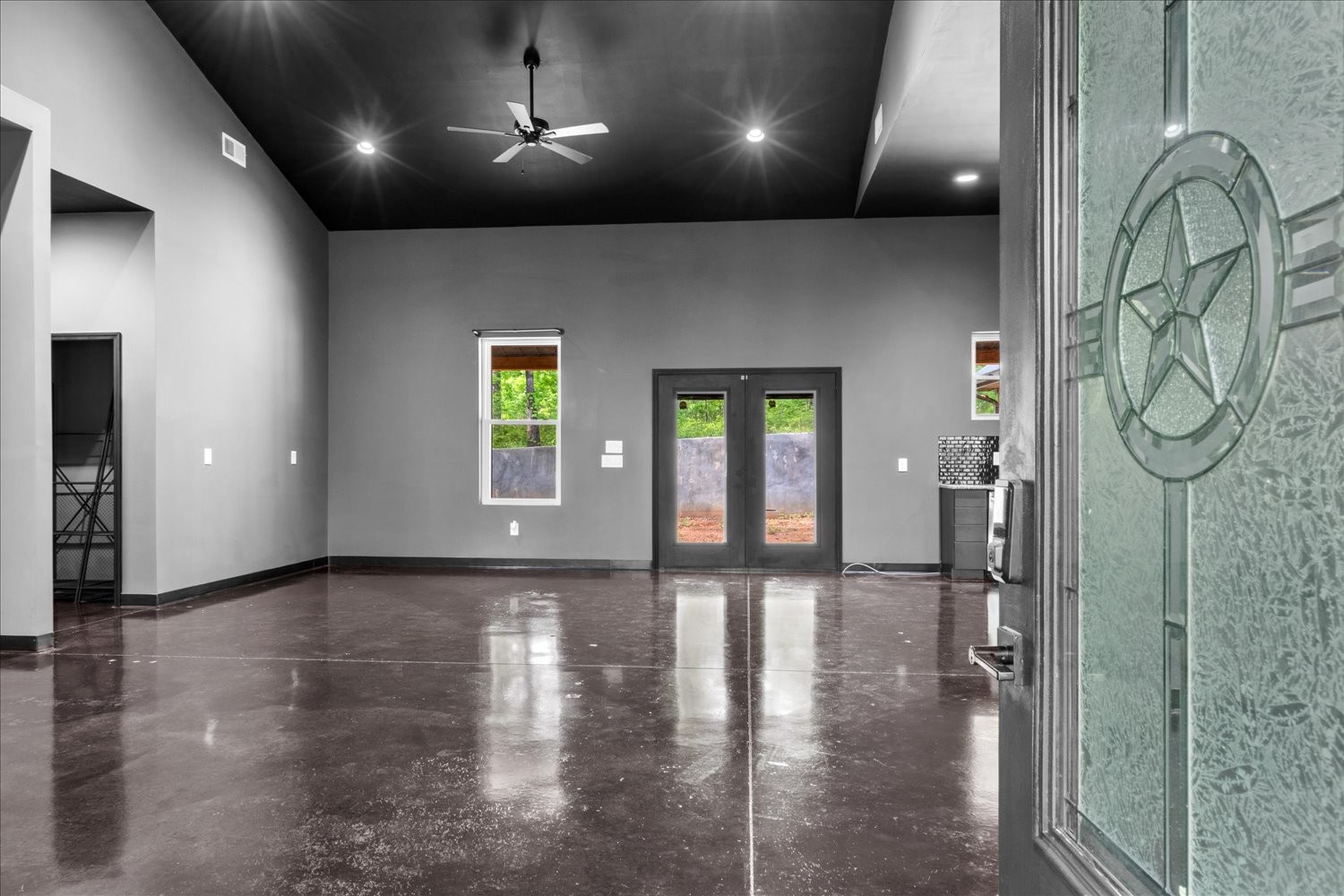 8360 Pinewood Road Lyles, TN 37098 - Photo 9 of 49 an empty room with wooden floor and windows