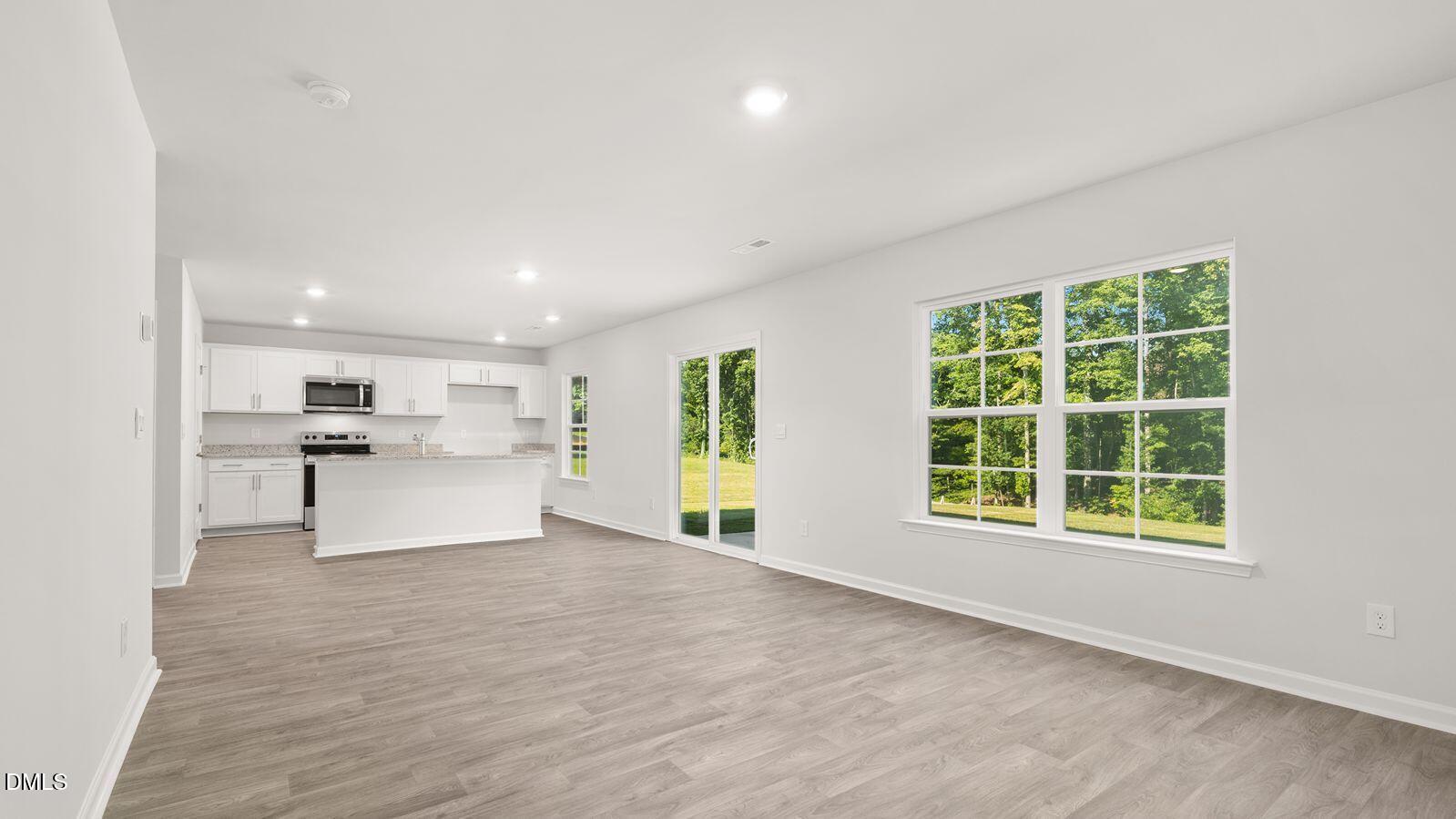 133 Daniel Road Wilson's Mills, NC 27577 - Photo 9 of 26 a view of kitchen with wooden floor and windows