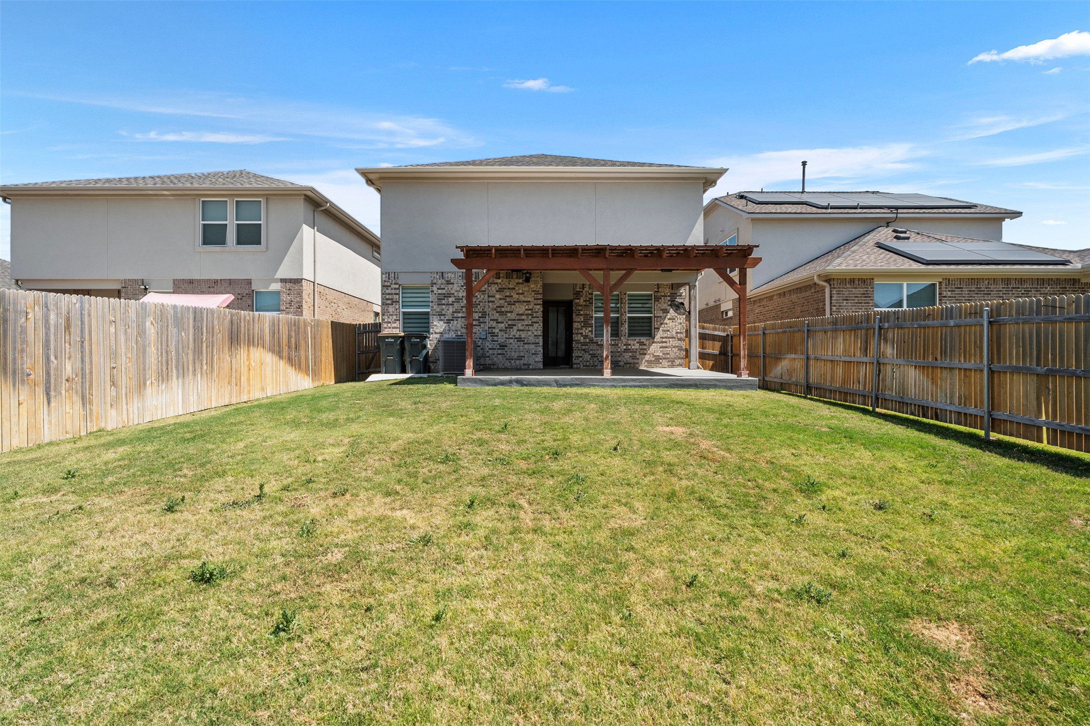 120 Ellinger Road Georgetown, TX 78626 - Photo 22 of 28 Expansive backyard featuring a concrete patio, a wooden pergola, and a privacy fence