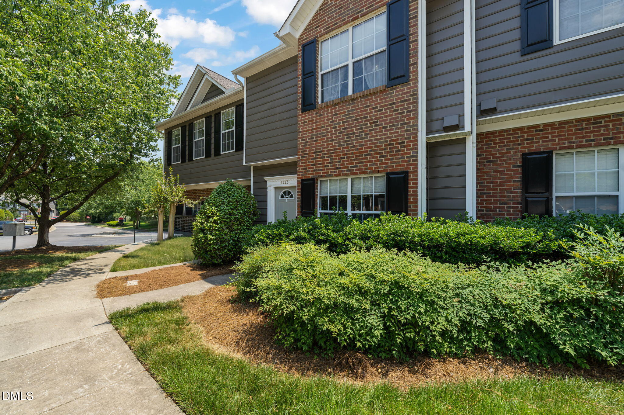 4323 Pine Springs Court Raleigh, NC 27613 - Photo 38 of 38 a view of a brick house with a yard and plants