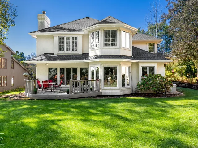 a front view of a house with a yard patio and swimming pool