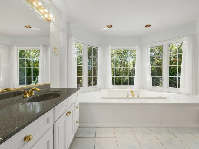 a view of a kitchen with a sink and large window