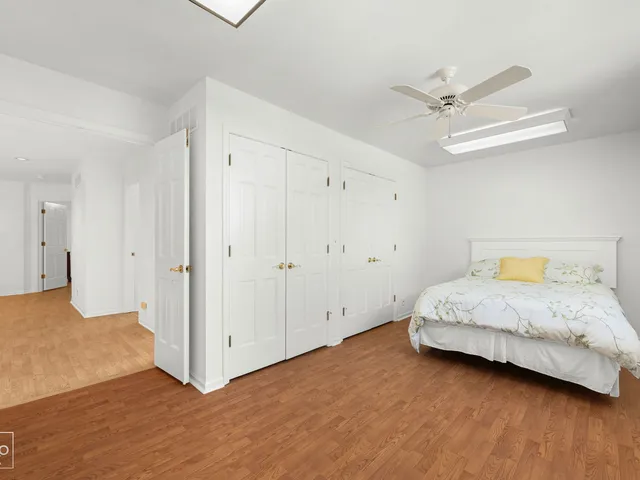 a bedroom with a bed and a ceiling fan