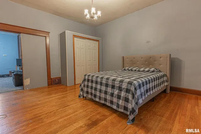 a bedroom with a bed and a chandelier