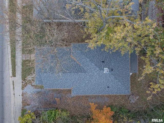 an aerial view of a house with a yard