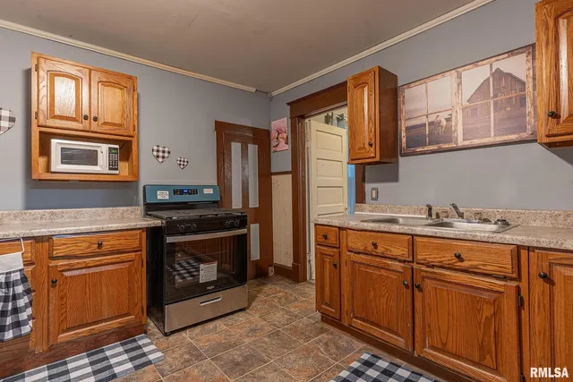 a kitchen with stainless steel appliances granite countertop a stove and a sink