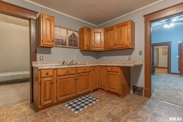 a kitchen with granite countertop cabinets and window